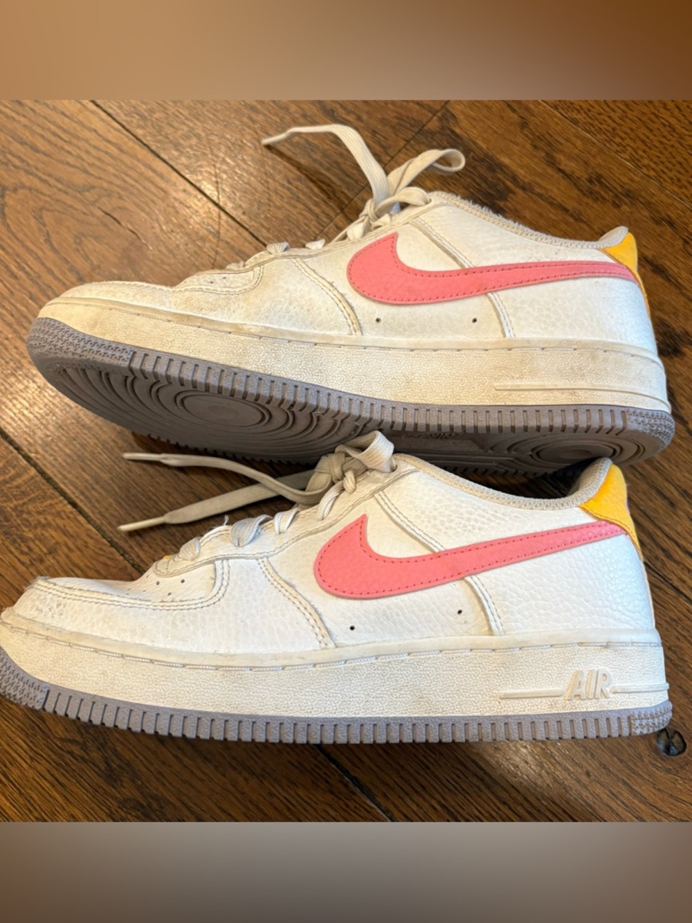 Nike Air Force 1 Low-Top Sneakers with Pink Swoosh and Yellow Heel Tab